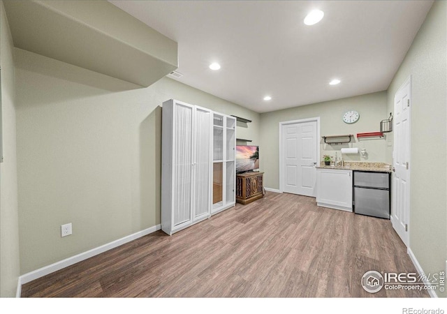 2707 Pochard Ct, Johnstown, CO 80534 - kitchen featuring refrigerator, light wood finished floors, open shelves, recessed lighting, and white cabinets