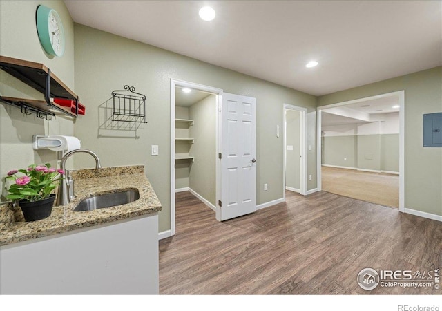 2707 Pochard Ct, Johnstown, CO 80534 - kitchen with wood finished floors, recessed lighting, light stone countertops, and electric panel