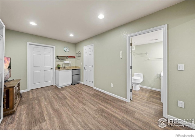 2707 Pochard Ct, Johnstown, CO 80534 - kitchen with wood finished floors, light countertops, recessed lighting, white cabinets, and open shelves