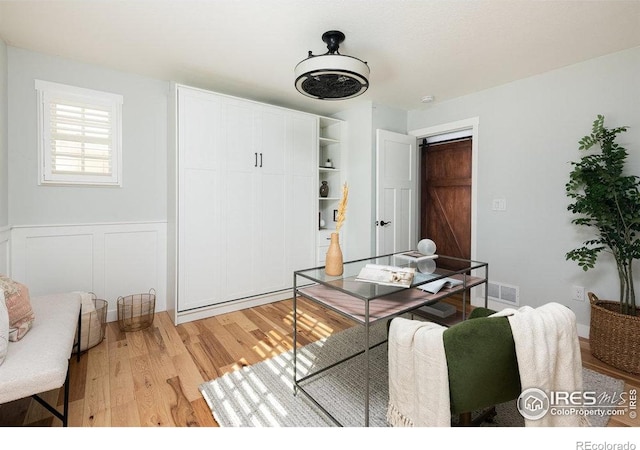 14117 W 58th Pl, Arvada, CO 80004 - dining space with light wood-type flooring and wainscoting