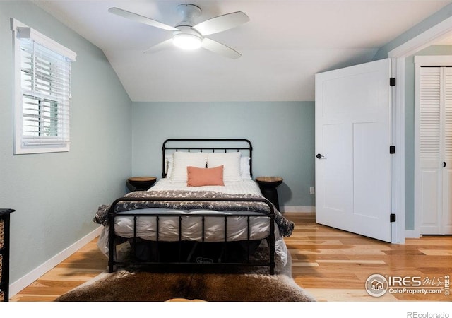 14117 W 58th Pl, Arvada, CO 80004 - bedroom with light wood-style flooring, vaulted ceiling, and a ceiling fan