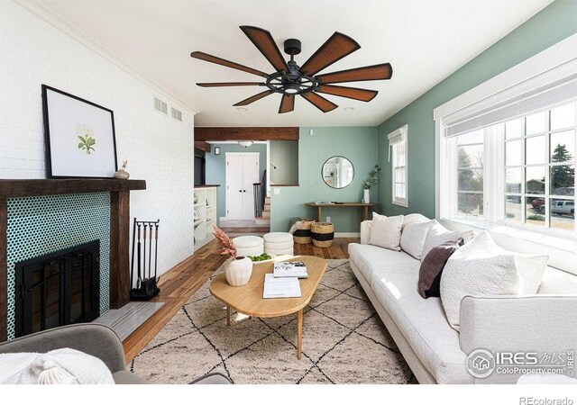 14117 W 58th Pl, Arvada, CO 80004 - living room featuring wood finished floors, ceiling fan, and a tiled fireplace
