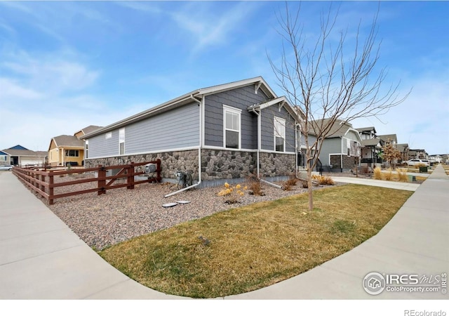 2156 Setting Sun Dr, Windsor, CO 80550 - view of home's exterior featuring stone siding and a residential view