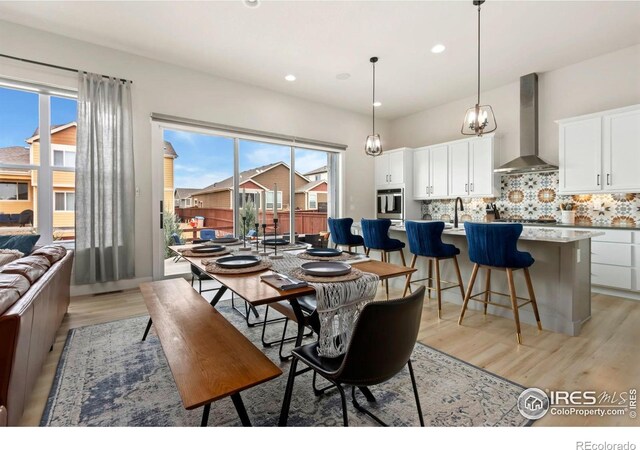 2156 Setting Sun Dr, Windsor, CO 80550 - dining area with light wood finished floors and recessed lighting