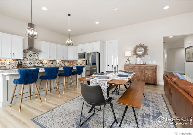 2156 Setting Sun Dr, Windsor, CO 80550 - dining room with light wood-style floors and recessed lighting