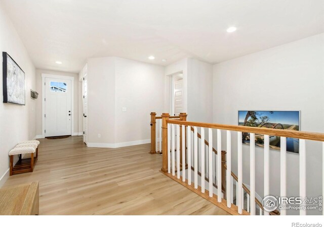 2156 Setting Sun Dr, Windsor, CO 80550 - hallway featuring an upstairs landing, wood finished floors, and recessed lighting