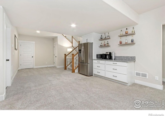 2156 Setting Sun Dr, Windsor, CO 80550 - interior space featuring appliances with stainless steel finishes, light carpet, open shelves, and white cabinetry