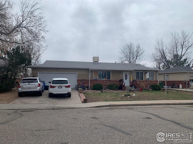 938 S Del Norte Ave, Loveland, CO 80537 - single story home featuring driveway, an attached garage, and brick siding