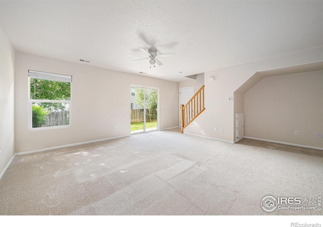 3314 Planter Way, Fort Collins, CO 80526 - unfurnished living room with stairway, carpet floors, a ceiling fan, and healthy amount of natural light