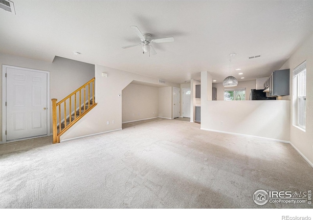 3314 Planter Way, Fort Collins, CO 80526 - unfurnished living room featuring a ceiling fan, stairs, and carpet floors