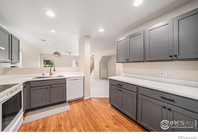 3314 Planter Way, Fort Collins, CO 80526 - kitchen with white appliances, light wood finished floors, gray cabinetry, recessed lighting, and light countertops