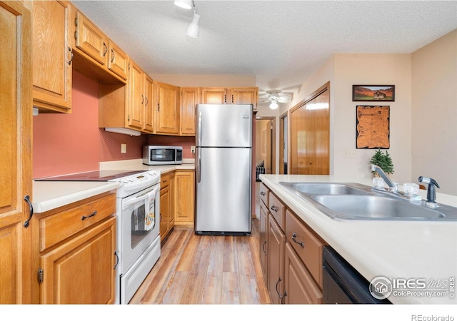 1795 Olympian Ln Unit A, Estes Park, CO 80517 - kitchen with appliances with stainless steel finishes, light wood-style floors, light countertops, and a textured ceiling
