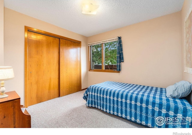 1795 Olympian Ln Unit A, Estes Park, CO 80517 - bedroom featuring a closet, carpet floors, and a textured ceiling