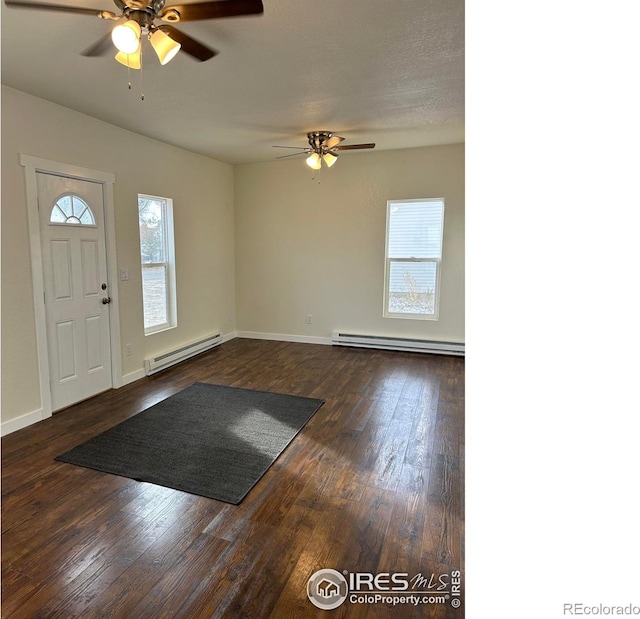809 Warren St, Weldona, CO 80653 - entryway featuring a baseboard radiator, ceiling fan, and dark wood-style flooring