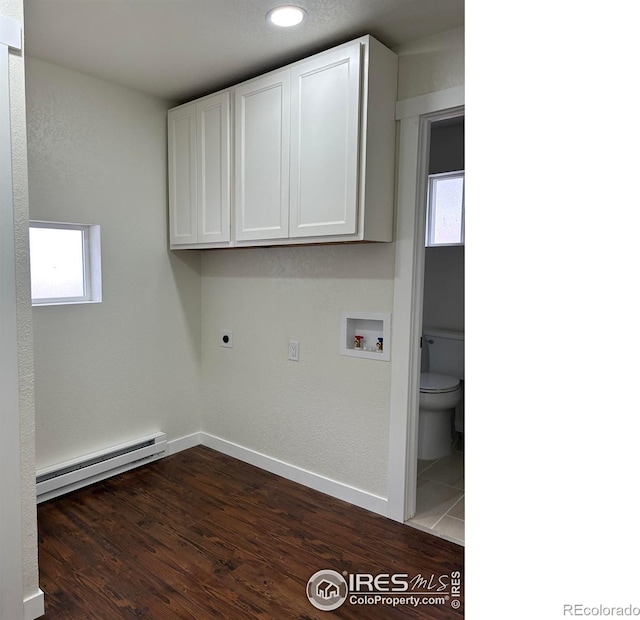 809 Warren St, Weldona, CO 80653 - laundry room featuring a baseboard heating unit, hookup for an electric dryer, cabinet space, hookup for a washing machine, and dark wood-style floors