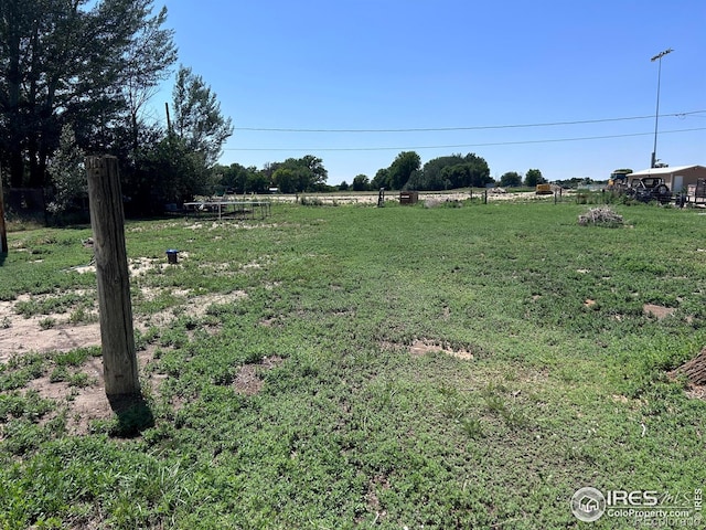 809 Warren St, Weldona, CO 80653 - view of green lawn featuring a rural view