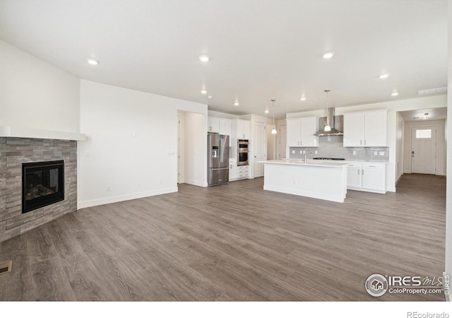 1842 Chaffee Crest Dr, Berthoud, CO 80513 - unfurnished living room with wood finished floors, recessed lighting, and a fireplace