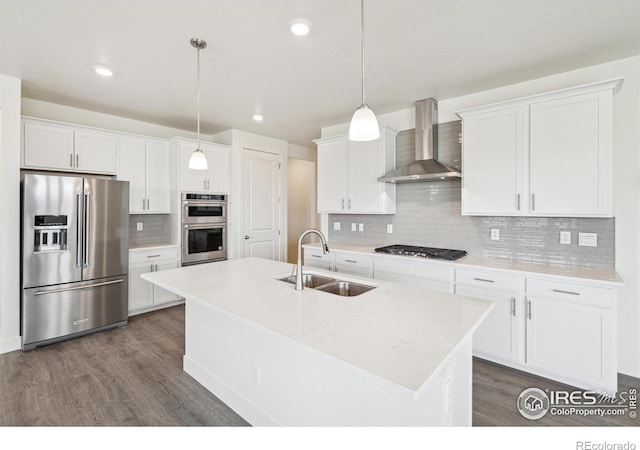 1842 Chaffee Crest Dr, Berthoud, CO 80513 - kitchen with appliances with stainless steel finishes, wall chimney exhaust hood, dark wood-style flooring, backsplash, and recessed lighting