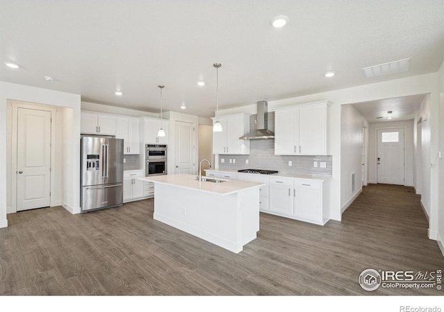 1842 Chaffee Crest Dr, Berthoud, CO 80513 - kitchen featuring stainless steel appliances, wall chimney exhaust hood, backsplash, wood finished floors, and recessed lighting