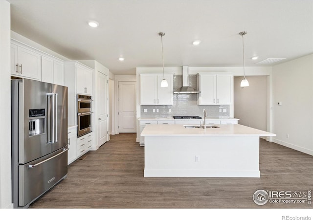 1842 Chaffee Crest Dr, Berthoud, CO 80513 - kitchen with stainless steel appliances, wall chimney exhaust hood, light countertops, dark wood-style floors, and recessed lighting