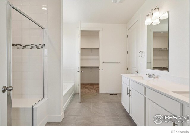 1842 Chaffee Crest Dr, Berthoud, CO 80513 - full bath featuring a spacious closet, a stall shower, a garden tub, and double vanity