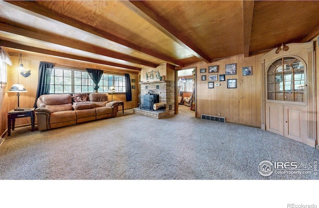 30 Falls Creek Dr, Bellvue, CO 80512 - carpeted living room featuring healthy amount of natural light, a wooden ceiling with exposed beams, wood walls, and a fireplace