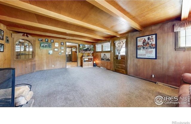30 Falls Creek Dr, Bellvue, CO 80512 - carpeted living room featuring wooden walls and a wood ceiling with exposed beams