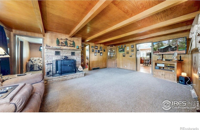30 Falls Creek Dr, Bellvue, CO 80512 - living room with wooden walls, carpet flooring, a fireplace, and a wooden ceiling with exposed beams