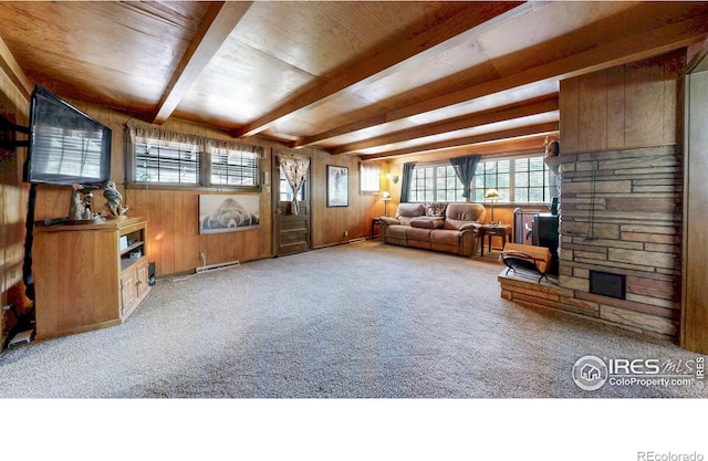 30 Falls Creek Dr, Bellvue, CO 80512 - carpeted living area with beam ceiling, plenty of natural light, wooden walls, and a fireplace