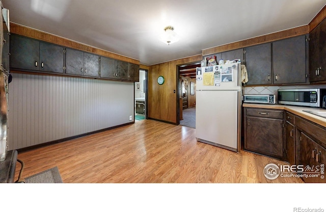 30 Falls Creek Dr, Bellvue, CO 80512 - kitchen with freestanding refrigerator, stainless steel microwave, light wood finished floors, and light countertops