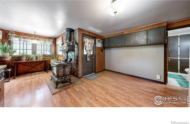 30 Falls Creek Dr, Bellvue, CO 80512 - entrance foyer with a wood stove, light wood finished floors, and wooden walls