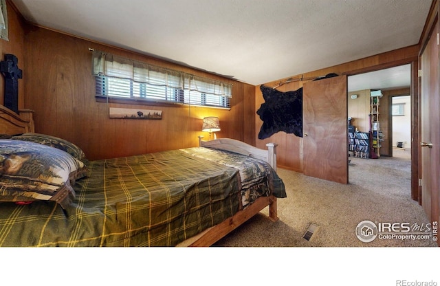 30 Falls Creek Dr, Bellvue, CO 80512 - carpeted bedroom featuring wood walls