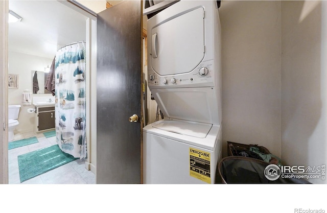 30 Falls Creek Dr, Bellvue, CO 80512 - washroom with estacked washer and dryer and tile patterned floors
