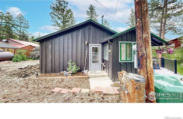 30 Falls Creek Dr, Bellvue, CO 80512 - mid-century inspired home featuring board and batten siding and a wooden deck
