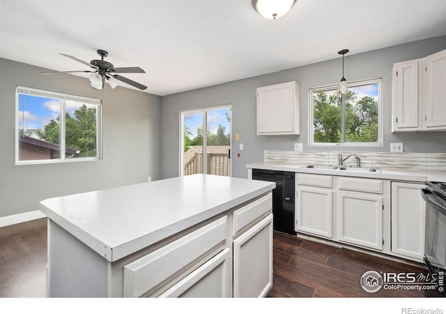 4740 Everglade Ct, Greeley, CO 80634 - kitchen featuring black dishwasher, dark wood-style flooring, white cabinetry, and light countertops