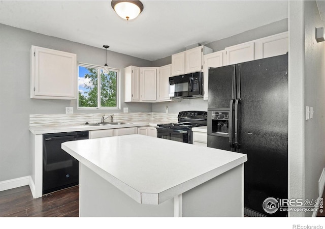 4740 Everglade Ct, Greeley, CO 80634 - kitchen featuring black appliances, dark wood-style floors, light countertops, white cabinets, and pendant lighting