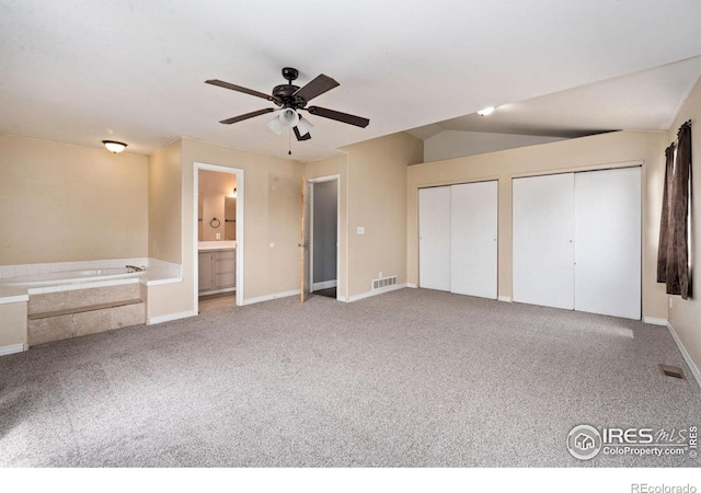 4740 Everglade Ct, Greeley, CO 80634 - unfurnished bedroom with carpet flooring, multiple closets, connected bathroom, and ceiling fan