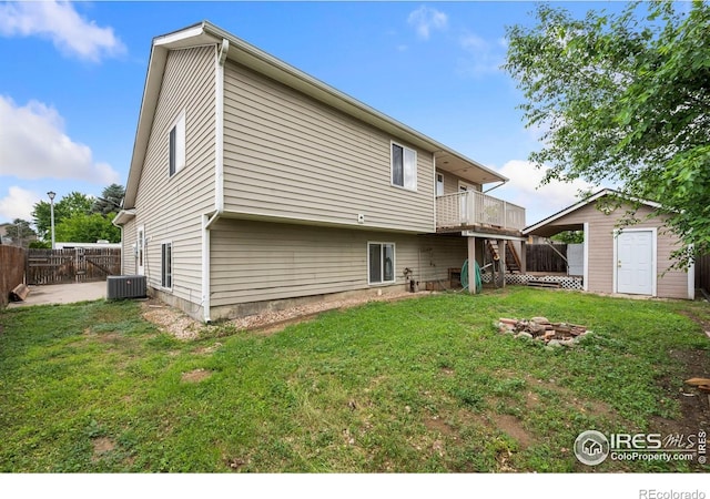 4740 Everglade Ct, Greeley, CO 80634 - rear view of property featuring a wooden deck, an outdoor fire pit, and a storage shed