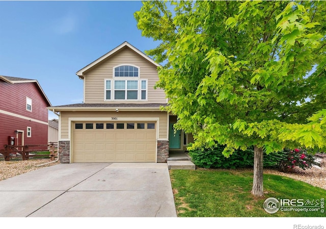 3001 Nebula Ct, Loveland, CO 80537 - view of front of home with stone siding, driveway, and an attached garage