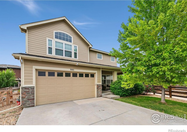 3001 Nebula Ct, Loveland, CO 80537 - view of front of home featuring stone siding, a garage, and driveway