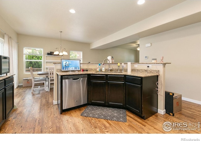 3001 Nebula Ct, Loveland, CO 80537 - kitchen featuring stainless steel dishwasher, light wood-style floors, recessed lighting, a chandelier, and light stone counters