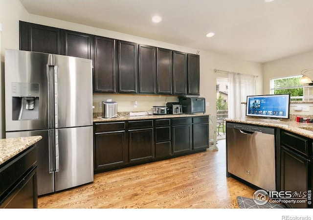 3001 Nebula Ct, Loveland, CO 80537 - kitchen featuring stainless steel appliances, light wood-style flooring, recessed lighting, and light stone countertops
