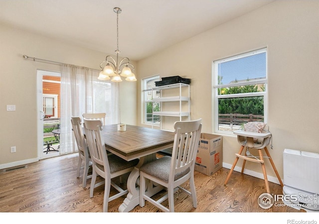 3001 Nebula Ct, Loveland, CO 80537 - dining area with a chandelier and wood finished floors