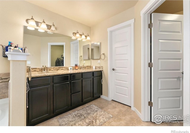 3001 Nebula Ct, Loveland, CO 80537 - bathroom featuring double vanity and tile patterned flooring