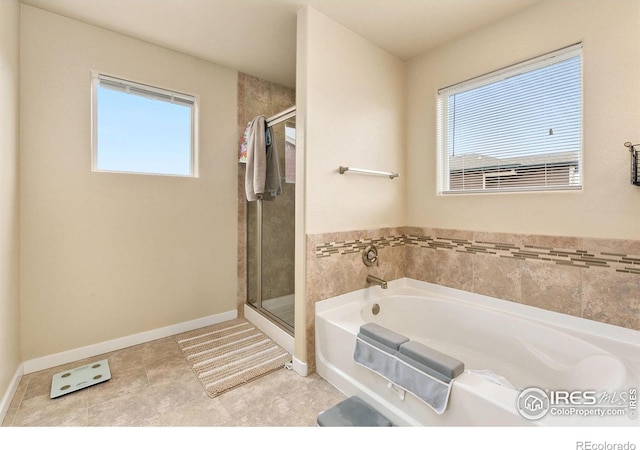 3001 Nebula Ct, Loveland, CO 80537 - bathroom with a bath, plenty of natural light, and a stall shower
