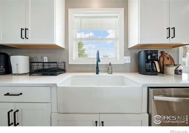34427 County Rd W, Hillrose, CO 80733 - kitchen with dishwasher, white cabinets, plenty of natural light, and light countertops