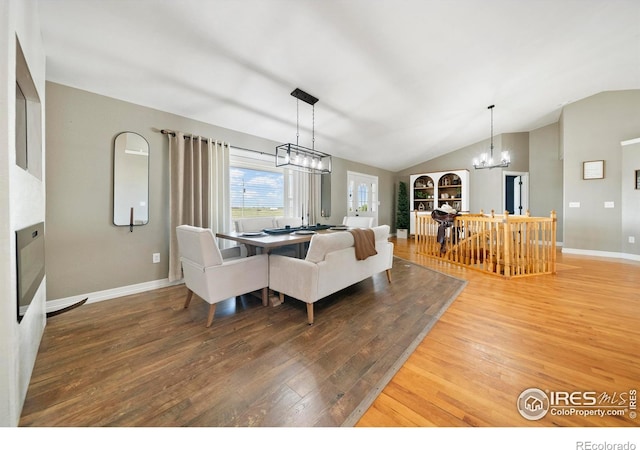 34427 County Rd W, Hillrose, CO 80733 - dining space featuring hardwood / wood-style flooring, lofted ceiling, and a chandelier