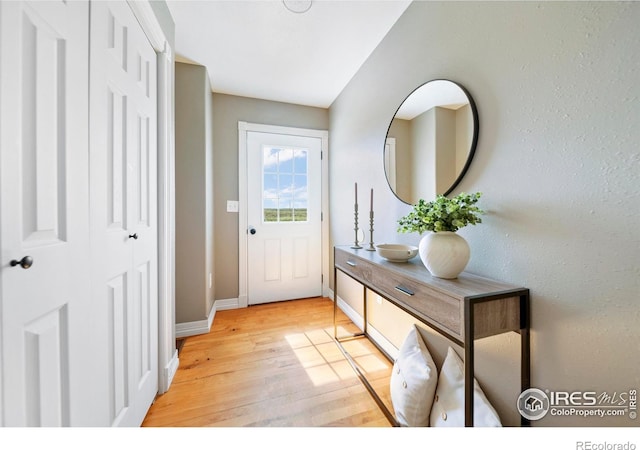 34427 County Rd W, Hillrose, CO 80733 - doorway to outside with light wood-style flooring and baseboards