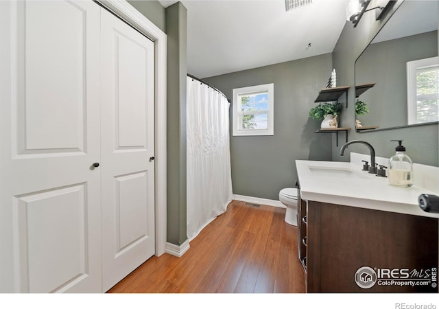 34427 County Rd W, Hillrose, CO 80733 - full bathroom featuring vanity, healthy amount of natural light, wood finished floors, and a shower with curtain