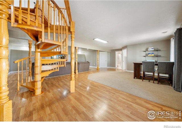 34427 County Rd W, Hillrose, CO 80733 - unfurnished living room with stairs and wood finished floors